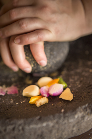 Crushing ingredients during a cooking classの写真素材