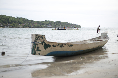 Fisherman with a fishing boat at Nusa Penida, near Bali, Indonesiaのeditorial素材