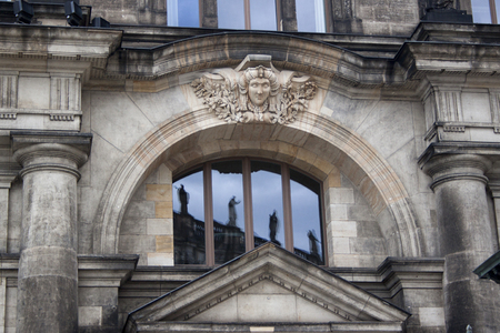 Reflection of statues in the windows of Dresden buildingの写真素材