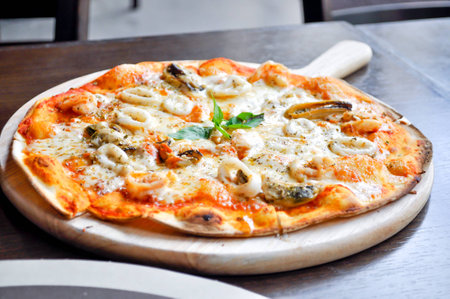 seafood pizza dish on the tableの写真素材