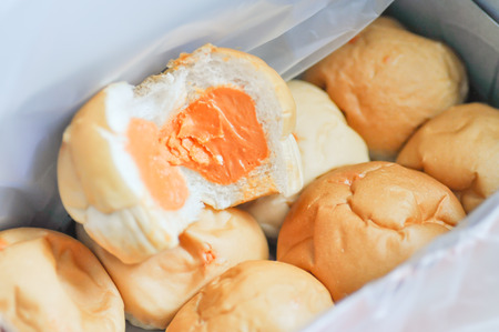 a box of bread with orange cream stuffの写真素材