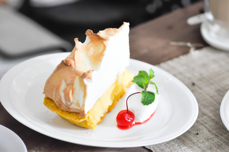 orange cake with cherry and creamの写真素材