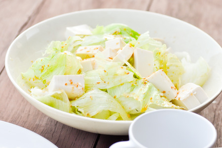 Iceberg lettuce and tofu salad dishの写真素材