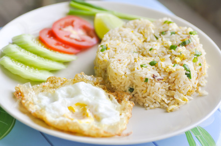 fried rice and fried egg with vegetableの写真素材