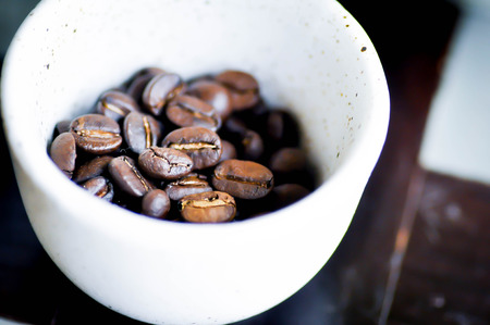coffee beans in a small cupの写真素材