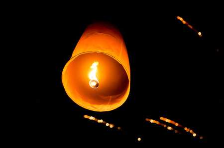 Sky lantern and fireworks or firecrackers in the night skyの写真素材