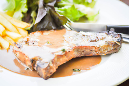 pork chop steak with vegetable and French friesの写真素材