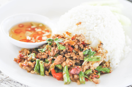 Rice topped with stir-fried pork and basilの写真素材