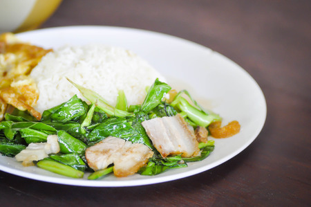 Stir Fried Kale with crispy pork dishの写真素材