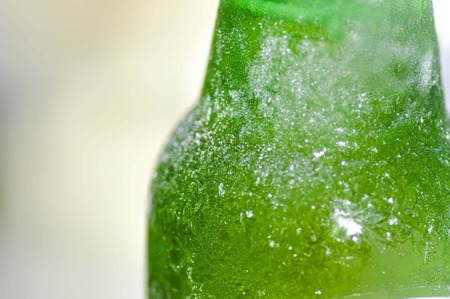 flake of ice on the green  bottleの写真素材