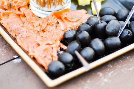 grilled salmon and black olive dishの写真素材