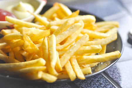 French fries with ketchup and mayonnaise dishの写真素材