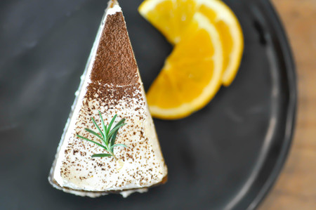 a piece of cake or tiramisu cake and orange
