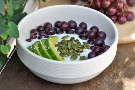 yogurt with grape and avocado toppingの写真素材
