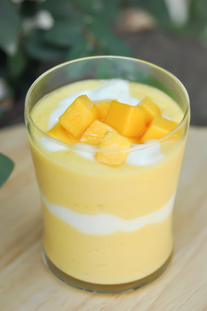mango smoothie or mango yogurt smoothie with mango toppingの写真素材