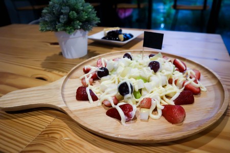 fruit salad and blueberry cheese cake on the tableの写真素材