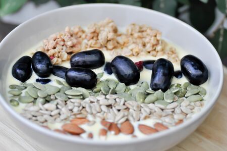 smoothie bowl,mango yogurt with fruit and almond toppingの写真素材