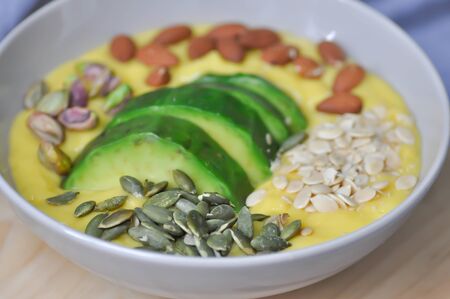 smoothie bowl, mango yogurt with avocado topping or blended mangoの写真素材