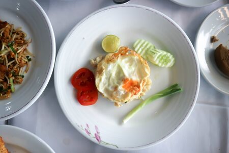 fried rice or stir-fried rice with fried egg and cucumberの写真素材