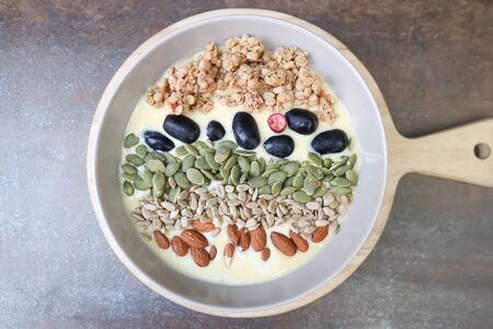 smoothie bowl,mango yogurt with fruit and almond toppingの写真素材