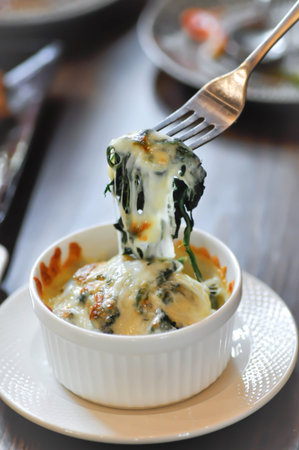 eating Baked spinach or Baked spinach with cheese,cheese spinachの写真素材