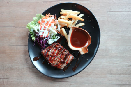 pork steak, French fries and saladの写真素材