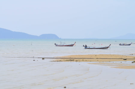 fishing boats near the sea and port in Phuket, Thailandの写真素材