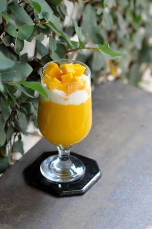 mango smoothie or mango yogurt smoothie with mango toppingの写真素材