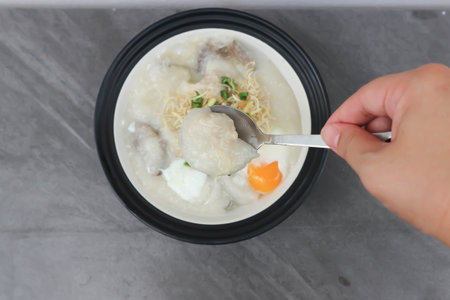 rice gruel or rice porridge or congee with pork liver, pork ball and egg