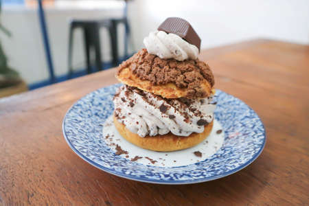 bun ,choux pastry with chocolate powder topping or eclair for serveの写真素材