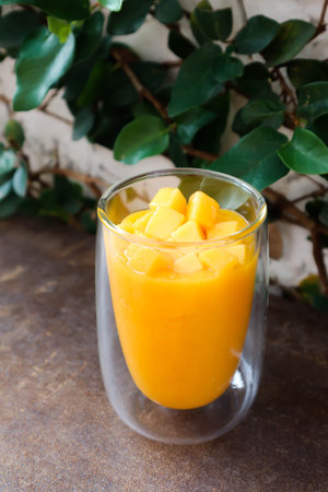 mango smoothie or mango yogurt smoothie , blended mango for serveの写真素材