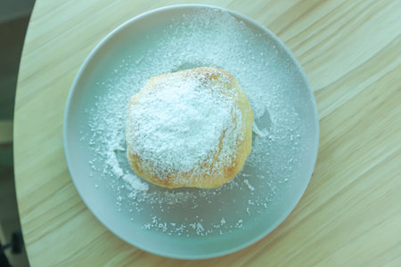 bun , bun or cream bun or butter bun with icing sugar or powdered sugar topping for serve