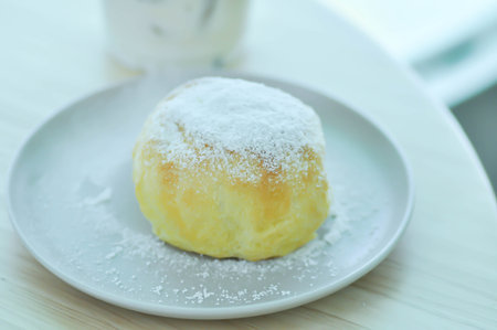bun , bun or cream bun or butter bun with icing sugar or powdered sugar topping for serve