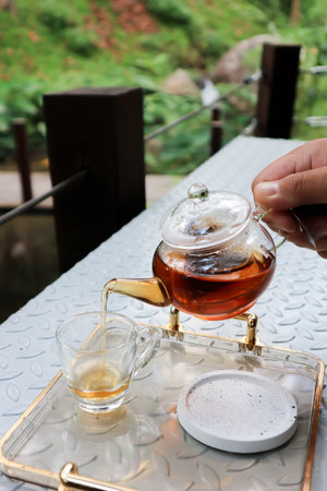 pouring tea , tea cup and tea pot for drink or English teaの写真素材