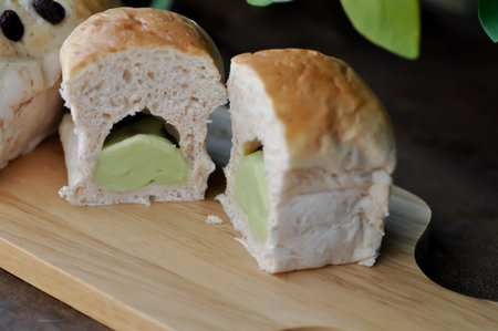 bread, thai custard bun or thai pandanus custard, thai pandanus custard bun, topping, touch food  bread or bun with custard stuffed or steamed custard bun in the trayの写真素材