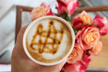 hot cofffee, caramel latte coffee or latte coffee in paper glass and vaseの写真素材