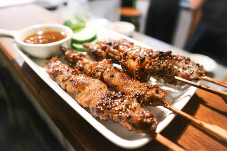 barbecued beef or grilled beef , beef satay with sauce and vegetableの写真素材