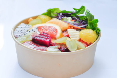 fruit and vegetable salad or orange, dragon fruit and lettuce salad in the box