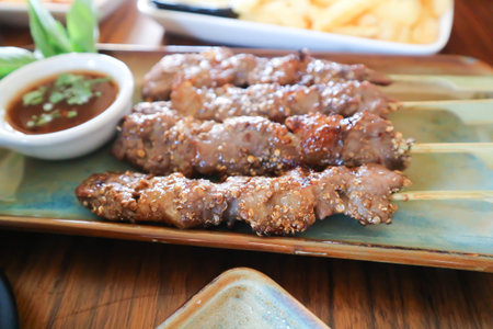 barbecued beef or grilled beef , beef satay with sauce and vegetableの写真素材