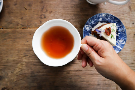 hot tea, tea cup and tea pot and carrot cake for serve