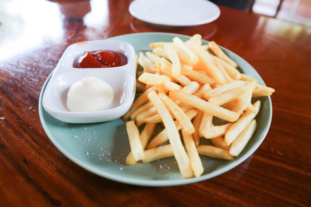 French fries or fried potato , fries with mayonnaise and tomato sauce or catchup