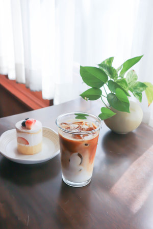 coffee, iced coffee or iced cappuccino coffee and strawberry shortcake on the table with the plant