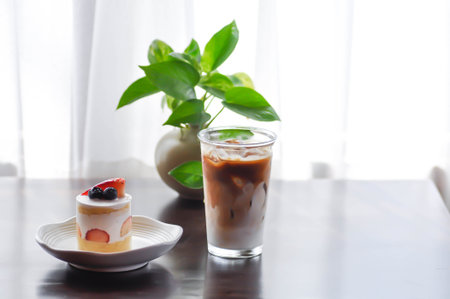 strawberry shortcake or strawberry cake with strawberry and blueberry topping and iced coffee or latte coffeeの写真素材