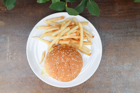 burger or pork burger or hamburger or beef burger , bun and French fries or fried potatoの写真素材
