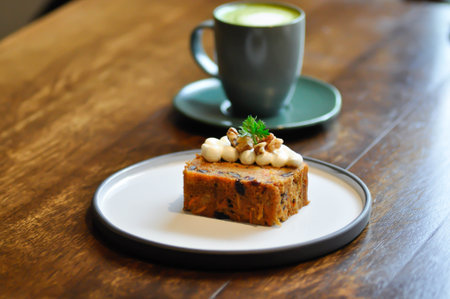 carrot cake with pecan and cream topping , pecan cake and green tea or matcha green tea for serveの写真素材