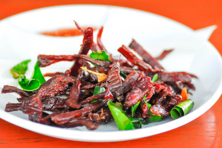 fried beef or deep fried beef with fried kaffir lime leafの写真素材