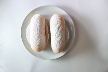 bun, bread or butter bread wih icing sugar topping