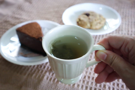 hot tea , cookie and cake on the table or tea time or hot green tea