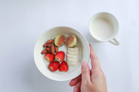 yogurt with fruit topping or strawberry, almond with fig and banana in natural yogurt and milk for serveの写真素材