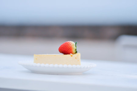 cheesecake with strawberry topping , cheese cake or piece of cakeの写真素材